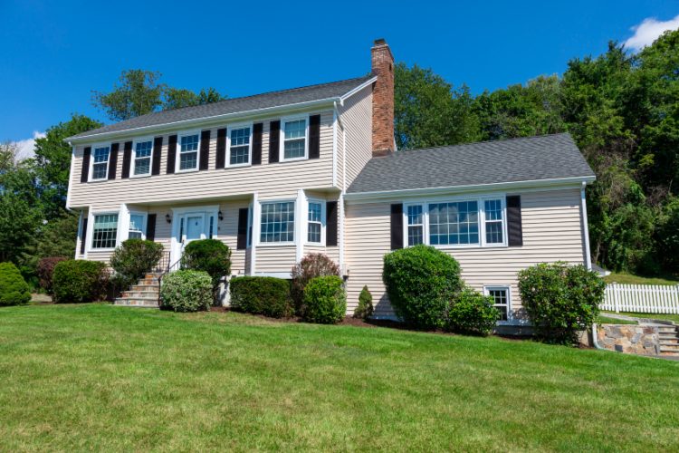 A large house with yard and driveway, representing Brooks Siding, Windows & Doors service areas.