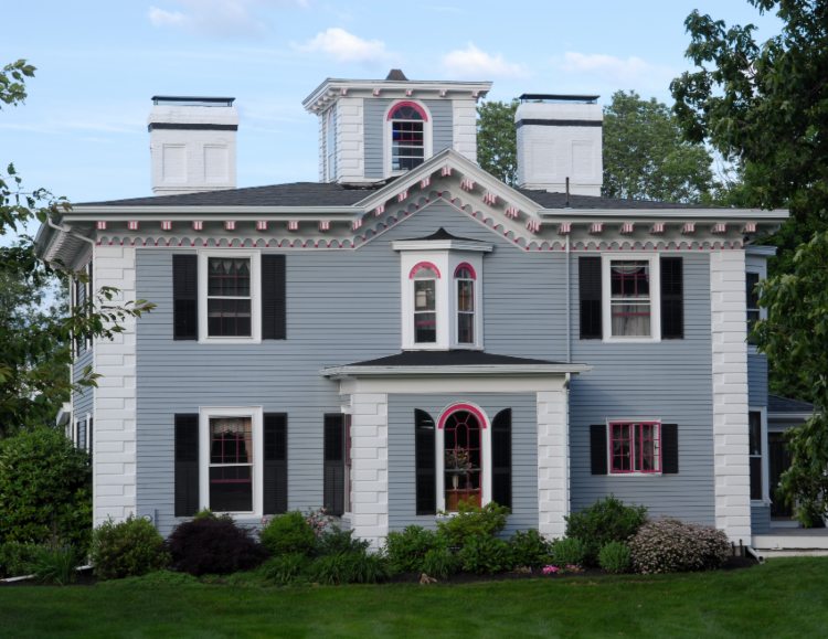 A blue house featuring pink & white trim, representing door and window installation in Haverhill, MA